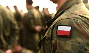 Żołnierz w mundurze z polską flagą. Czy warto iść do wojska? To pytanie, na które każdy musi odpowiedzieć sam.