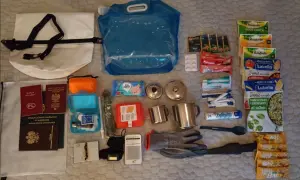 Zestaw survivalowy: plecak jako bagaż rejestrowany, paszporty, woda, jedzenie, apteczka, kubki, rękawice, radio.